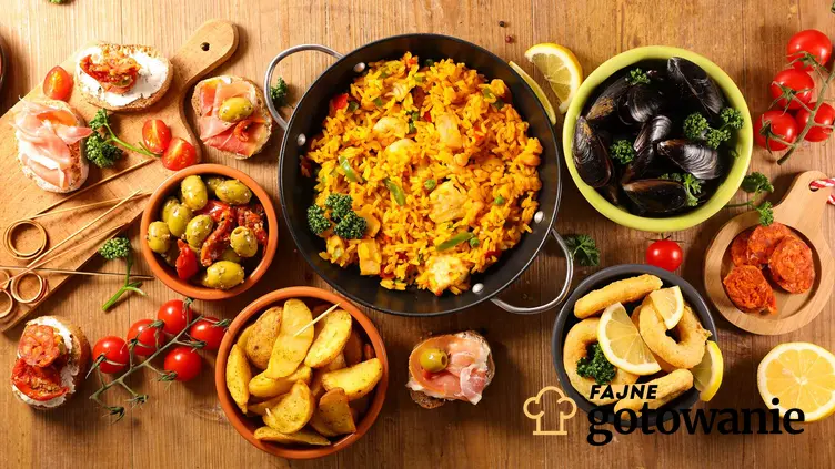 Na stole ustawione są naczynia z daniami, które są charakterystyczne dla kuchni hiszpańskiej